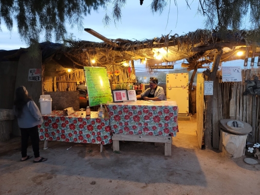 Customer approaches the open-air order counter at The Stand restaurant