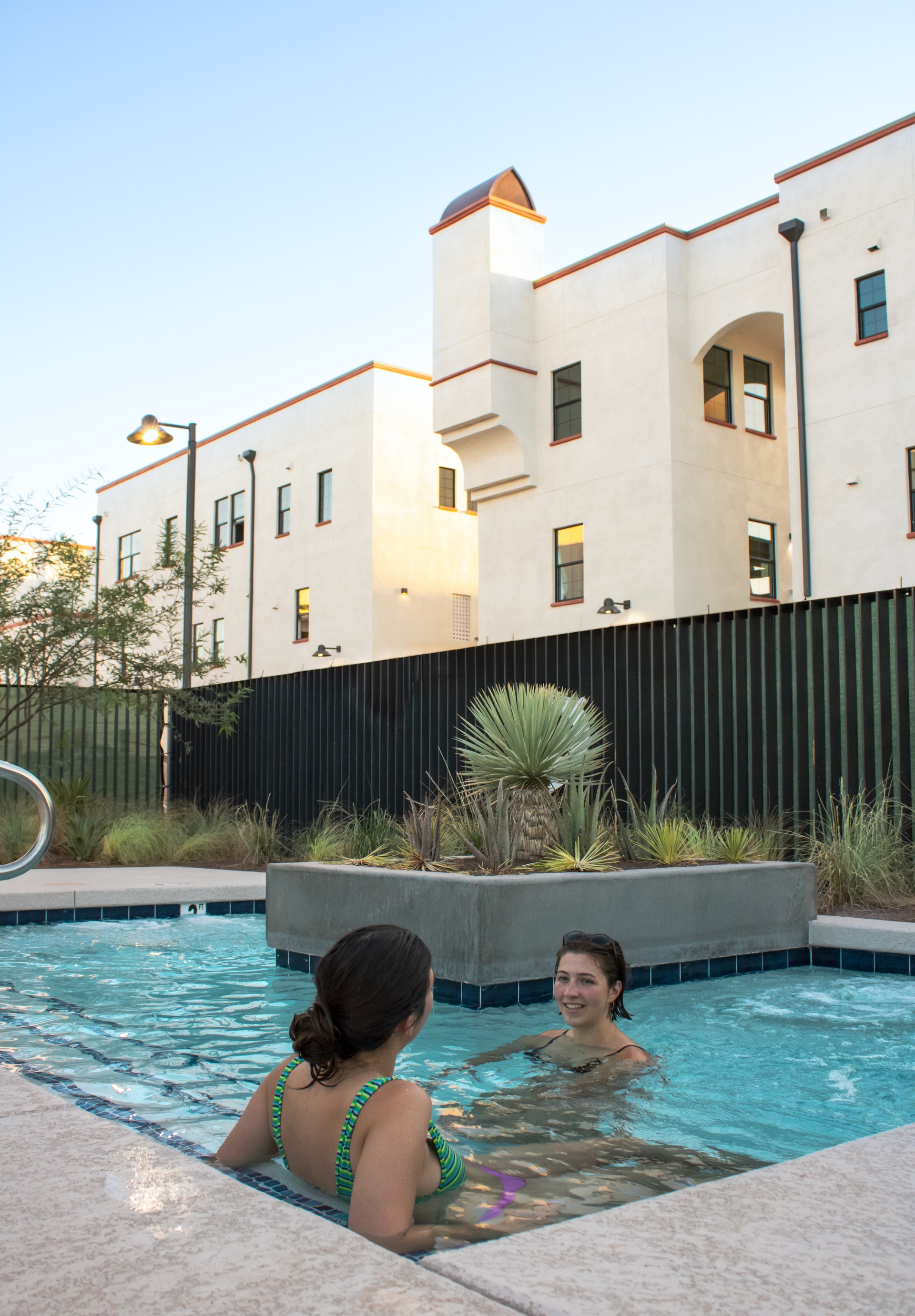 Photo of two people in hot tub with planter in the middle