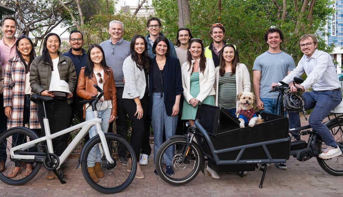 Team photo with ebike and dog in cargo bike in the office parklet