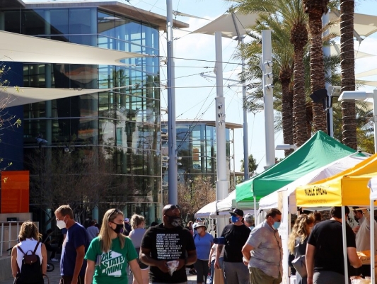 People shopping stalls at the Downtown Mesa Farmers Market