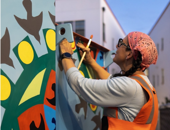 Artist painting a mural