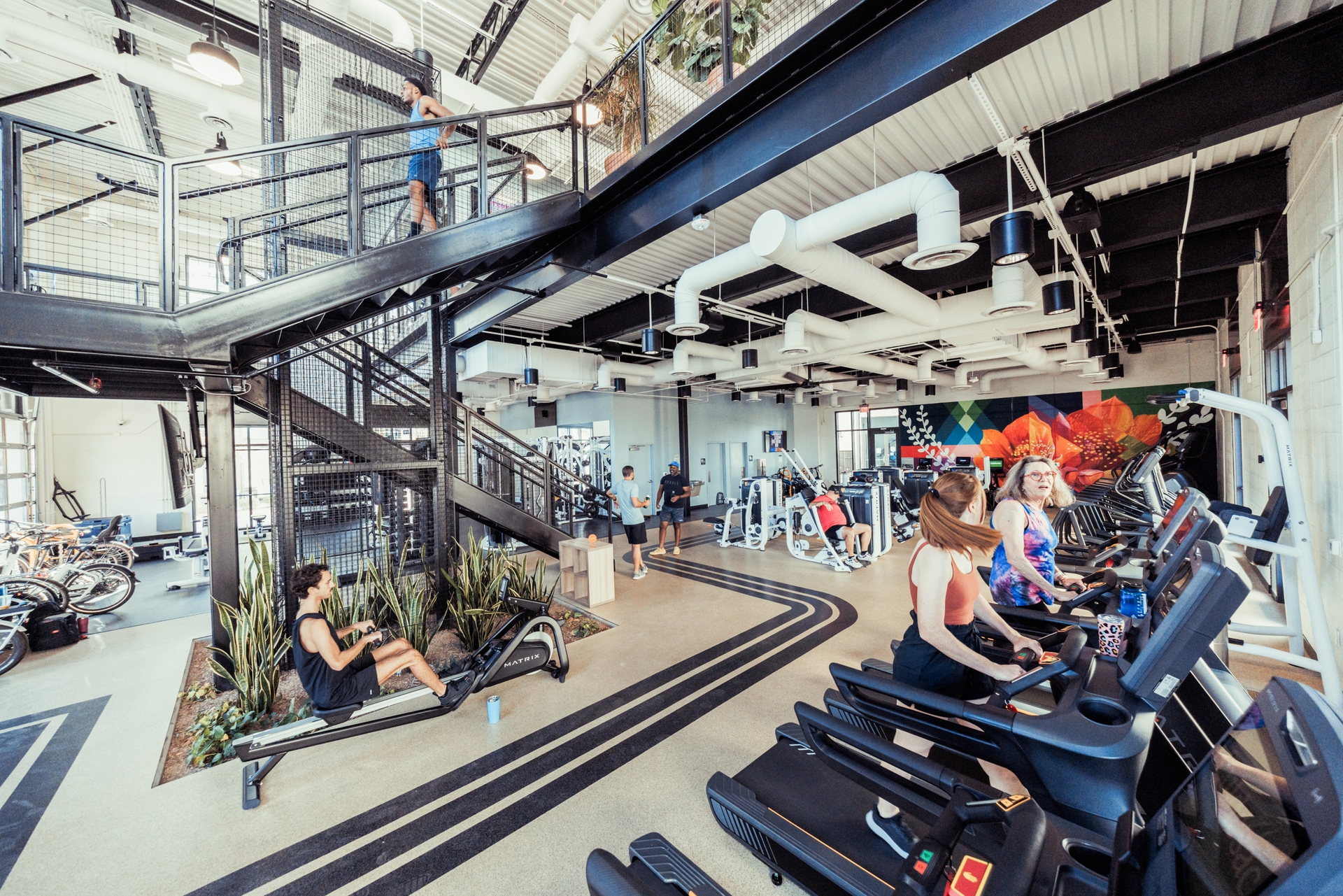 Two-story Culdesac gym with people on treadmills on the bottom level